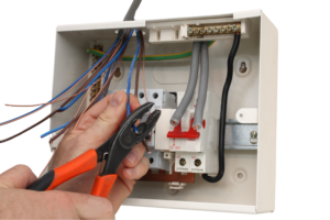 A picture of an electrician fitting an electrical consumer board.